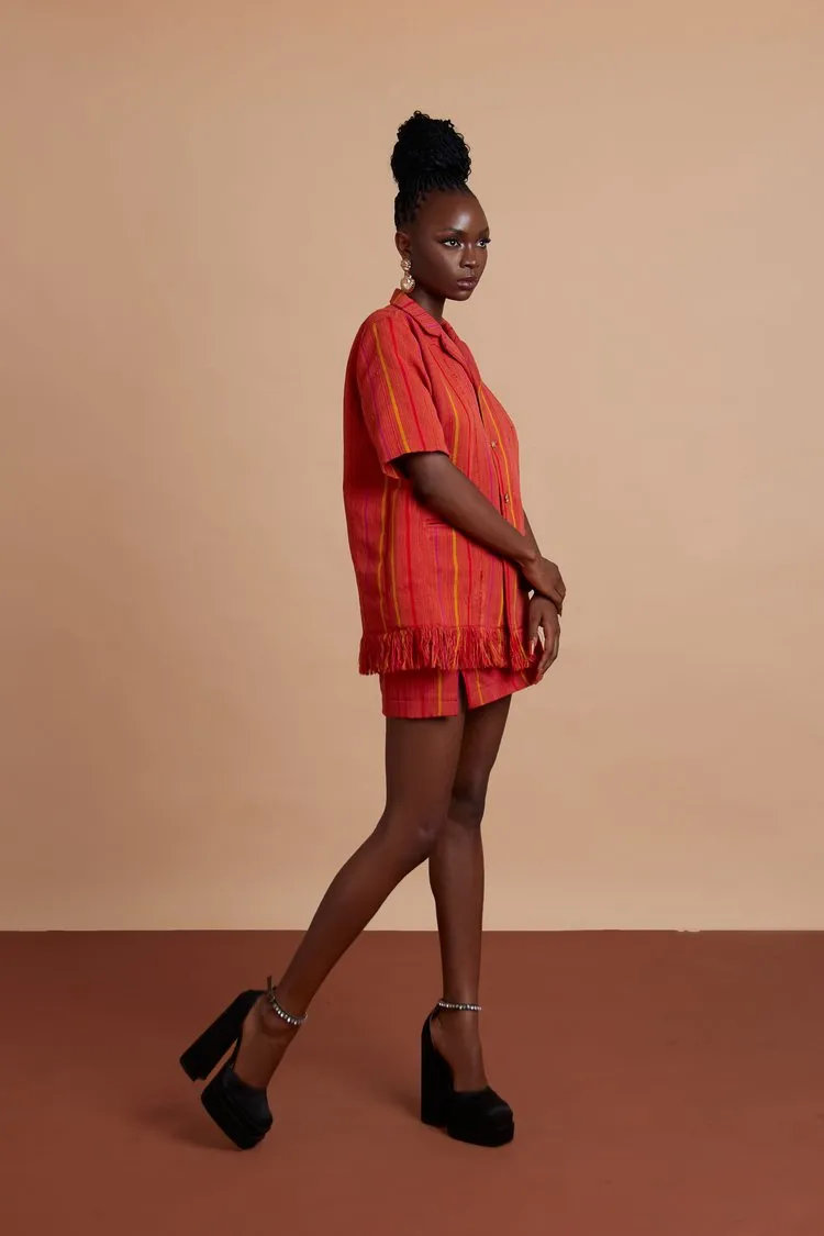 Jermaine Bleu shirt with hand-frayed hem and Brass buttons with High-waisted mini skirt with thigh slit detail LoLa Jo Set